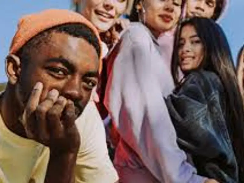 A group of young adults smiling together outdoors